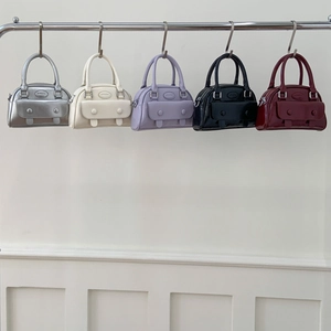 Chic Boston handbags for women in diverse colors like silver, cream, and burgundy
