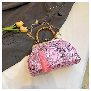 Detail of pink paisley embroidery silk bag with bamboo handle and golden clasp