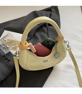 Detail shot of a yellow crescent bag showing open interior space for phone and wallet
