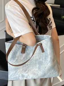 Chic blue washed texture tote bag with brown leather handles for daily commuting
