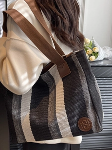 Vertical striped canvas tote bag in black and beige with leather details and wide strap