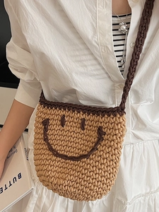 Japanese style hand-woven straw bucket bag with smiley face pattern and crossbody strap