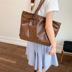 Brown PU leather tote bag with knotted shoulder strap and matching small pouch