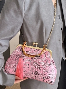 Pink paisley handbag with bamboo handle, gold metal clasp and detachable chain strap