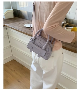 Lilac purple retro handheld underarm bag with double buckle flap shown in lifestyle scene