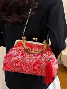 Red Chinese embroidery handbag with bamboo handle and elegant silk tassel detail