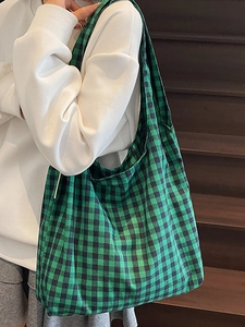 Japanese retro green and black checkered canvas tote bag worn on a shoulder