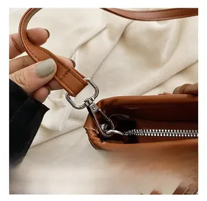 Detail view of brown PU leather tote with silver metal hook and decorative silk scarf