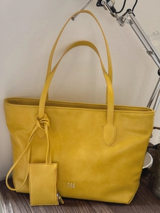 Fashionable large yellow leather tote bag with silver PAN TOR logo and knotted handles