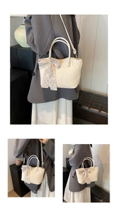 Detail of off-white pleated tote bag with checked scarf handle and shoulder strap