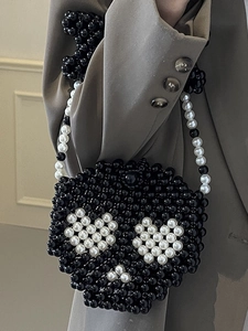 Handmade black beaded handbag with unique skull shape and black white chain strap