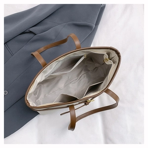 Detail shot of the spacious interior with zippered pocket in a stylish tote bag