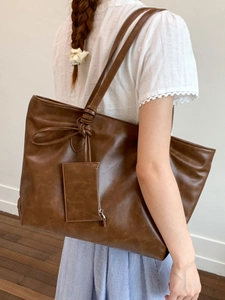 Brown large capacity tote bag with knotted strap and small pouch for women