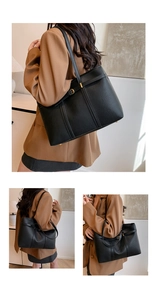 Close-up of black lychee grain leather tote bag with slim shoulder straps and metal buckle