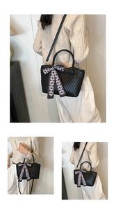 Detail of black pleated tote bag showing matelasse texture and checkered ribbon bow