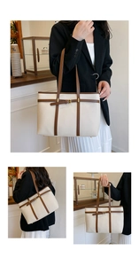Macro detail of creamy white lychee grain tote bag with dark brown strap and gold buckle