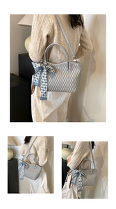 Detail of light blue wavy texture tote bag with a blue plaid silk scarf handle decoration