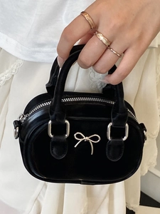 Mini black velvet handbag with silver bow detail and metallic handles in French style