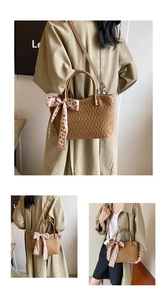 Detail view of brown faux leather tote with wave stitching and pink silk bow accessory