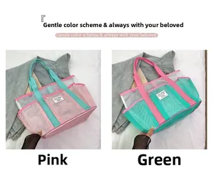 Mesh tote bag detail showing large capacity and contrasting pink and green woven handles