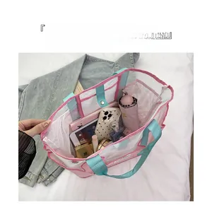 Macro detail of high-capacity mesh beach bag showing organized inner compartments and items