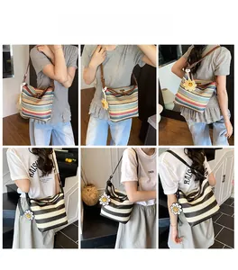 Detail view of woven straw tote bags with colorful stripes and floral charms