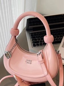 Pink patent leather crescent handbag with silver metal logo and chain strap decoration