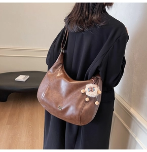 Borsa hobo in pelle marrone con ampia tracolla e dettaglio di ciondolo a pecora peluche