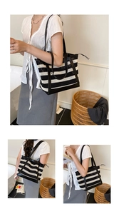 Detail of a large striped woven tote bag featuring reinforced black handles and a spacious interior
