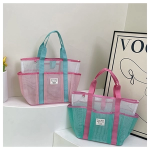 Mesh swimming bags in pink and green colors on a minimalist decorative display shelf