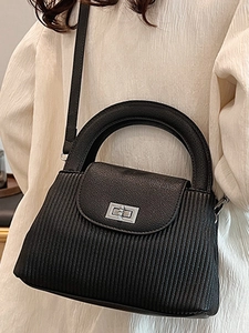 Elegant black pleated handbag with vertical stripes and silver metal lock closure