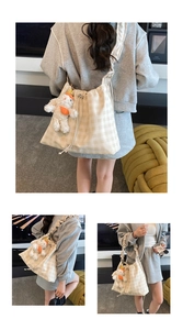 Detail of checkered canvas tote bag with drawstring closure and plush bunny charm