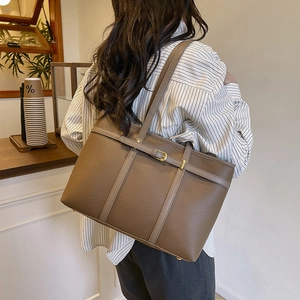 Brown litchi grain leather tote bag with large capacity and golden buckle detail