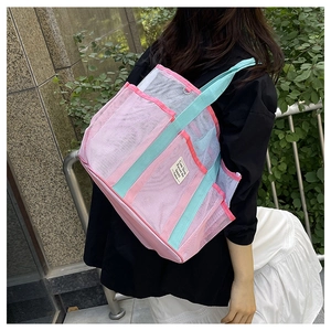 Pink and mint green mesh tote bag shown on a model for beach or gym usage