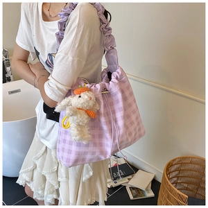 Detail of lavender checkered tote bag with ruffled strap and cute rabbit pendant charm