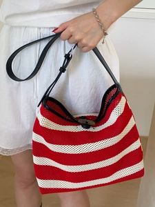 Woven red and white striped tote bag with mesh design and black leather straps