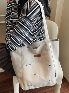 Large beige canvas tote bag with cute dog embroidery and premium brown leather logo patch