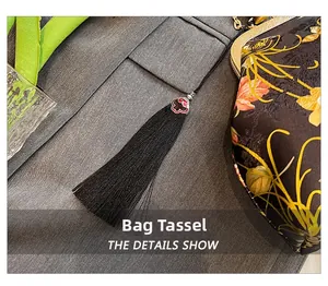 Detailed macro view of black silk tassel with vintage floral patterned shell bag