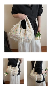 Detail of hand-knitted beige tote bag with colorful pearl beads and fringe accents