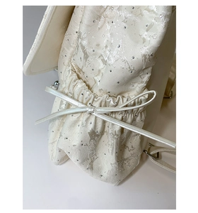 Detail of silver butterfly backpack with pearlescent fabric and sparkling rhinestones