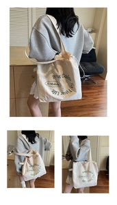 Detail of canvas tote bag showing drawstring closure and Bring Color To Your Life print