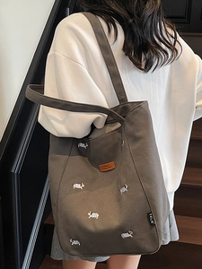 Minimalist dark gray canvas tote bag with embroidered dog patterns for casual daily use