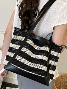 Summer striped woven tote bag with black leather straps for commute and vacation