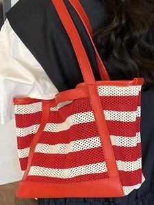 Red and white striped mesh tote bag for women shown as a stylish shoulder carry on model