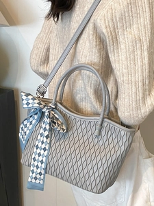 Grey wave-textured tote bag for women featuring a blue checkered bow on the strap