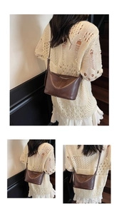 Détails d'un sac sous le bras vintage marron avec fermeture éclair et coutures fines