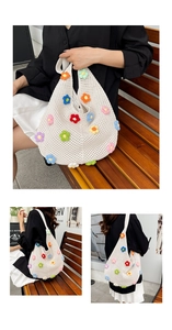 Detail showing colorful handmade crochet flowers on a white woven tote shoulder bag