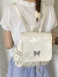 Silver butterfly backpack with subtle pattern and metallic logo for stylish daily travel