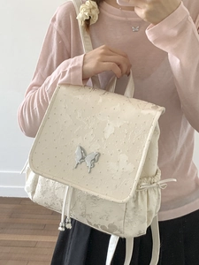 Chic cream floral jacquard backpack with metallic butterfly and drawstring bow details