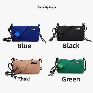 Detail view of cylinder shoulder bags in blue, black, khaki, and green nylon fabric